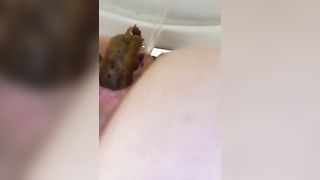 Amateur chick in mask pooping in the toilet