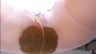 Woman shitting a lot of diarrhea in pantyhose