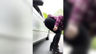 Lady shits beside her car