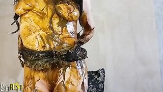 Brunette girl smearing shit heavily on her boobs