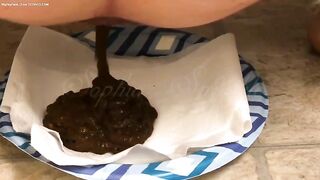 Babe shits on paper napkin on a plate.