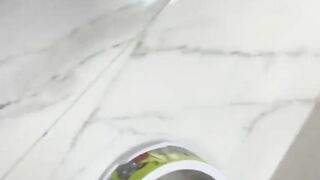 Filling the container with her poop