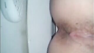 Shitting a dark turd in the toilet closeup