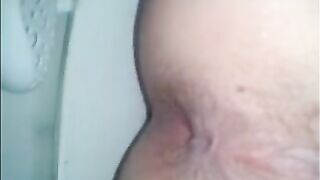 Shitting a dark turd in the toilet closeup