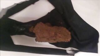 Girl in black panties shits