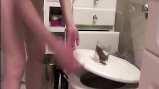 Blonde shitting in a glasses and showing her tight asshole