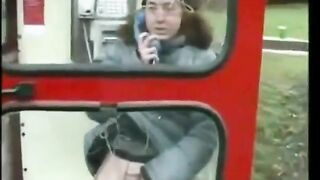 Lady pisses in a phone booth