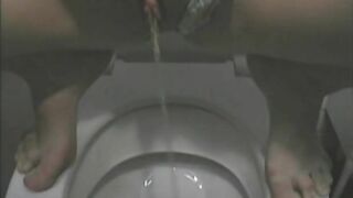 Pretty blonde lady poops in the toilet