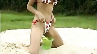 Hot Sahara pissing in sandbox