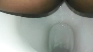 Naughty ebony lady poops in the toilet