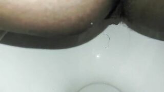 Naughty ebony lady poops in the toilet