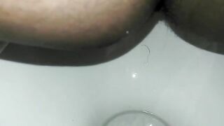 Naughty ebony lady poops in the toilet