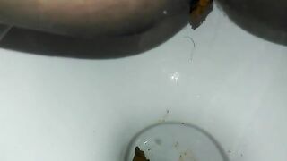 Naughty ebony lady poops in the toilet