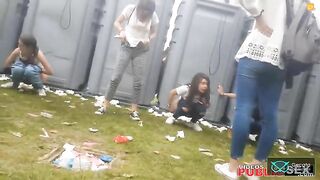 Girls poops at a festival while her friend stands nearby