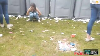Girls poops at a festival while her friend stands nearby