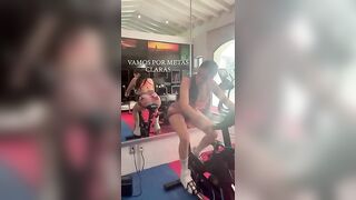 Girl flashes ass while riding a fitness machine