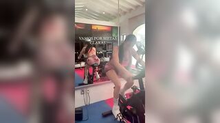Girl flashes ass while riding a fitness machine