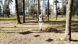 Blonde in a forest squats to take a shit