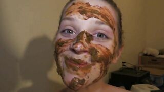 Lovely brunette girl covers herself with shit