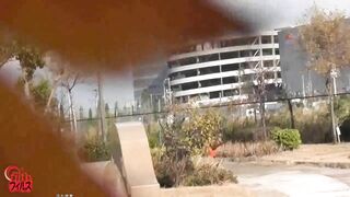 Two girls stand on shit covered floor in public bathroom
