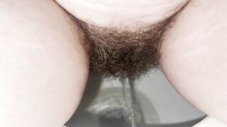 Amateur hairy lady pissing in the toilet