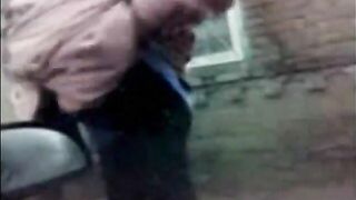 A chubby woman shits in her pants outside