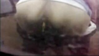 A chubby woman shits in her pants outside