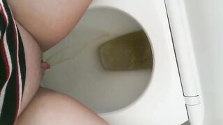 Girl pisses on a toilet full of shit