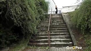 Sexy blonde babe on stairs pee