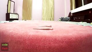 Girl handfucks her asshole with a mirror on the bed