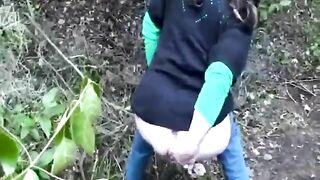 Chick dropping shit in the grass