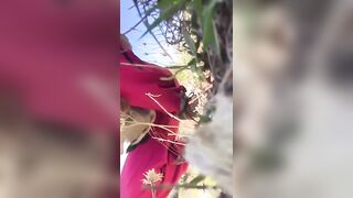 Lady caught shitting in the tall grass