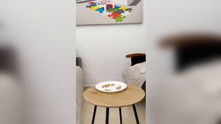 Girl defecating on a plate from a squat