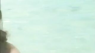 Girl in water plays in her own piss