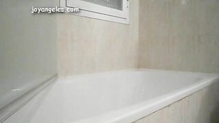 Girl squats in a bathtub and takes a shit on the floor