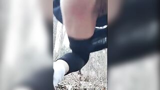 Woman squats and shits in a field