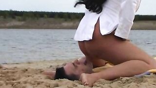Woman takes a shit on a yellow towel while outdoors