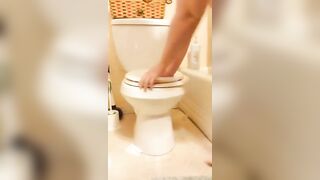 Girl takes a shit on a toilet bowl and spreads it