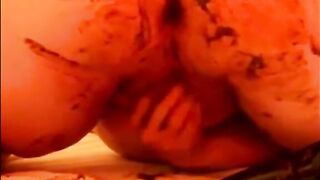 Woman plays with her shit on a bed