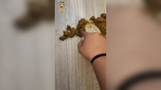 Girl takes a shit on the wooden floor and wipes it up with her hands