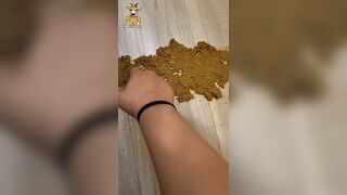 Girl takes a shit on the wooden floor and wipes it up with her hands