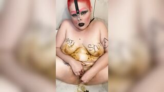 Girl with shit all over her body plays with a purple dildo