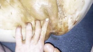 Woman spreads her ass cheeks while covered in shit