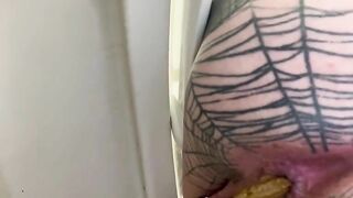 Woman sits on the toilet and drops a small pile of shit
