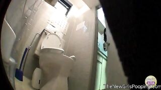 Woman takes a shit in a public toilet