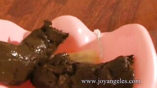 Woman takes a shit on a pink stool