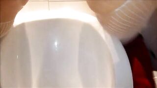 Girl squats on a toilet and takes a big shit while looking down