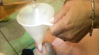 Woman drinks a cup of piss from a man's cock