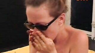 Girl takes a shit on mattress while holding her ass cheeks apart.