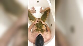 Guy takes a huge shit in the bathtub and covers his legs